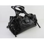 A black patent handbag by Kookai approx 38cm wide, some wear noted to corners.