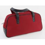 A red fabric and black leather bag by Fiorelli approx 33cm wide.