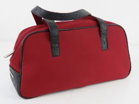 A red fabric and black leather bag by Fiorelli approx 33cm wide.