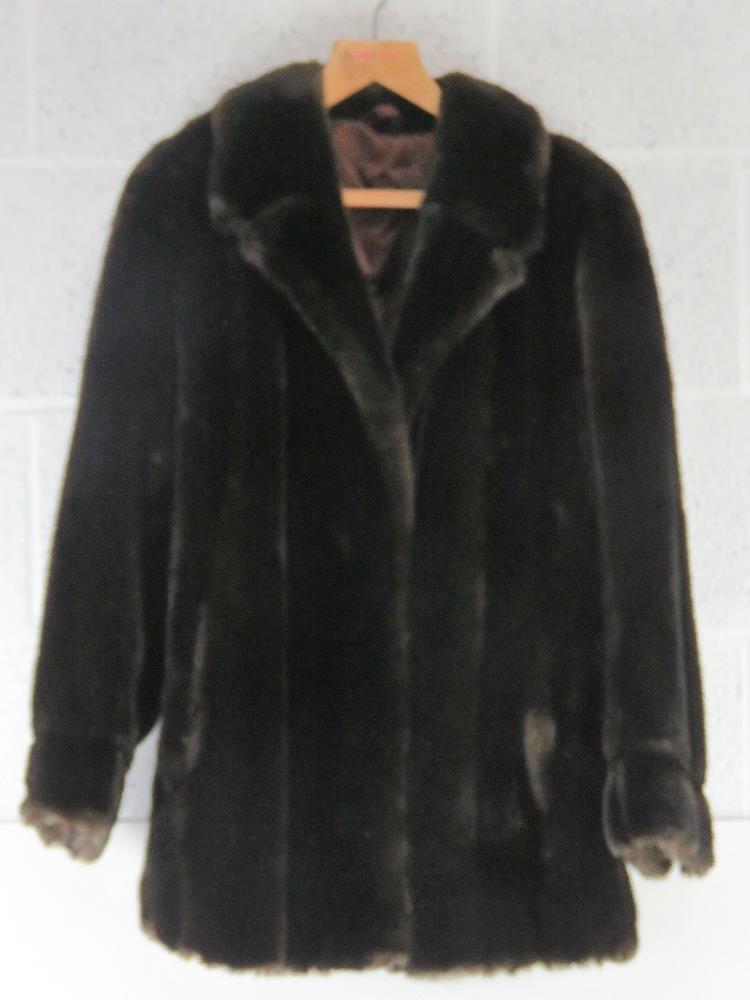 A faux fur jacket approx measurements; 40" chest, 31" length at back and 17" sleeve underarm.