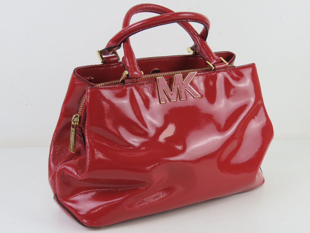 Michael Kors; a red patent handbag with original paper shopping bag and dust bag, approx 31cm wide. - Image 2 of 4