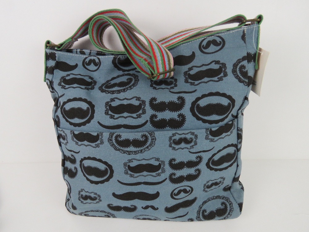 A fabric tote bag having mustache pattern in blue 'as new', approx 38 x 34cm.