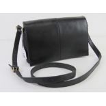 A vintage black leather cross body handbag approx 26cm wide.