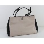 A blush and black leather handbag by Fiorelli approx 35cm wide.