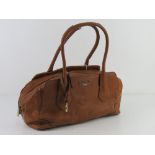 A tan leather handbag by Fiorelli approx 35cm wide. Slight wear noted to handles.