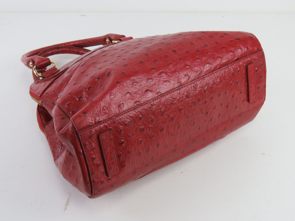 Jasper Conran; a red leather handbag having three sectional compartment approx 37cm wide. - Image 2 of 5