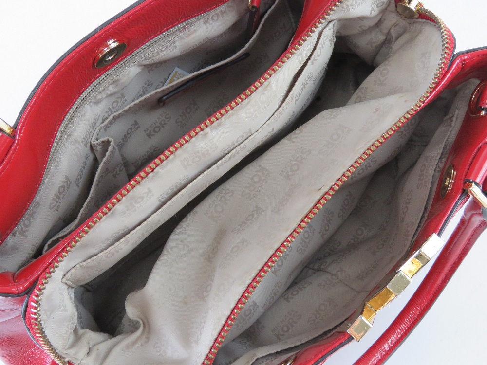 Michael Kors; a red patent handbag with original paper shopping bag and dust bag, approx 31cm wide. - Image 4 of 4