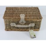 An as new wicker picnic hamper for two including thermal lining, cutlery, plates, bottle opener,