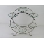 A chrome and glass candle stand 34cm high.