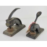 Two vintage cast iron stamps, one for Lewis Coates and Lupus Ltd,