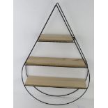 A contemporary three-shelf wall unit in the form of a teardrop, black metal, 65 x 42cm.