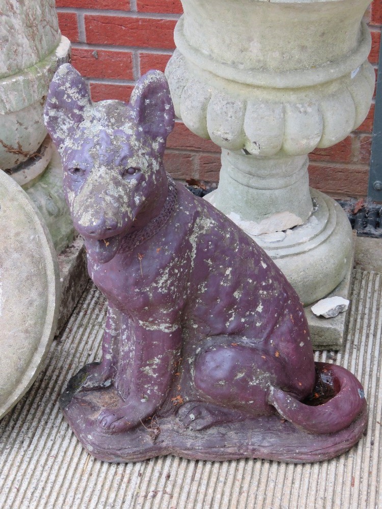 A pre-cast garden statue of an Alsatian / German Shepherd.