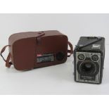 Two vintage cameras; Kodak 8 movie camera f/1.9, and a Kodak Six-20 'Brownie' E.
