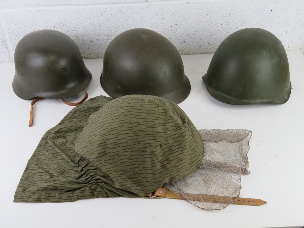 Four assorted military helmets each with