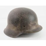 A WWII German M42 single decal (indistinct) semi relic Afrika Korp Army helmet.