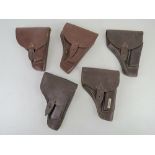 Five PPK leather holsters.