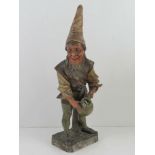A continental plaster figurine of a gnome with water jug standing 51cm high.