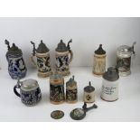 A quantity of 20thC ceramic beer steins having assorted themes, one with lithophane to base, most