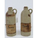 Two stoneware bottles bearing labels for Parsnip Wine and Birch Wine, each standing 24cm high.