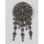 An impressive 19th century cut steel brooch having central floral panel with wreath surrounding and