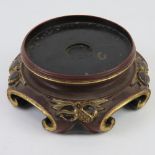 An Oriental lacquered hardwood stand, ebonised with red and gilt decoration upon, dia approx 10cm,