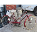 A vintage Raleigh bicycle with accessories.