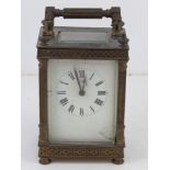 A French made five glass brass cased carriage clock. Enamelled face and Roman numerals, all before