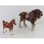 A German figurine of a horse together with another figurine of a Shire horse in bridle etc. Two