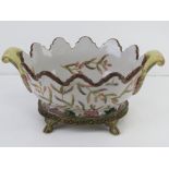 A hand painted ceramic basket style centrepiece bowl raised over brass stand and decorated with