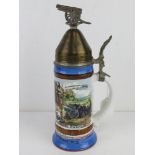 A military themed beer stein having fuze style lid with cannon decoration upon, German