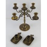 A brass fire sconce candelabra together with a pair of German brass chamber sticks.