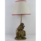 A heavy cast brass table lamp in the form of a classical female having oak leaf coronet, for