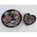 Moorcroft; a round dish 18.5cm dia, together with a heart shaped smaller dish.