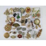 A quantity of 20thC costume jewellery brooches inc pewter Labrador pin, embroidered brooch, German