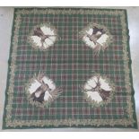 A German hunting themed tablecloth by Franchris having stags and two moose upon with tartan type