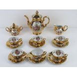 A 1920s Royal Bavaria Handgemalt gilded tea service comprising six cups and saucers, teapot, cream