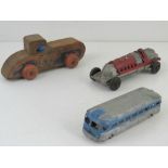 An American made cast metal racing car toy together with Greyhound Line bus and wooden US Scout