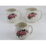 A set of three graduated Beswick chintz creamware jugs having pink floral design upon.