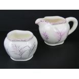 Avon Ware, England; A delightful hand painted cream and sugar bowl set, having lilac feather