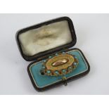 A delightful Victorian brooch set with turquoise and having glazed mourning locket panel to back,