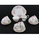 A Paragon China tea service comprising six trios (cups, saucers, side plate), milk jug, sugar bowl