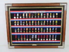 A framed display of replica 'British Miniature Campaign and Gallantry medals',