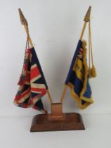 A pair of vintage tabletop desk flags being The Royal British Legion and the Union Flag.