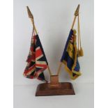 A pair of vintage tabletop desk flags being The Royal British Legion and the Union Flag.