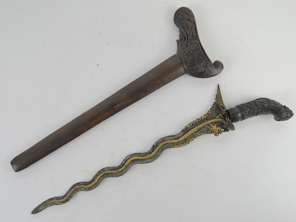 A Kris knife with scabbard having gold gilt blade, with hand crafted and carved scabbard and handle. - Image 2 of 3