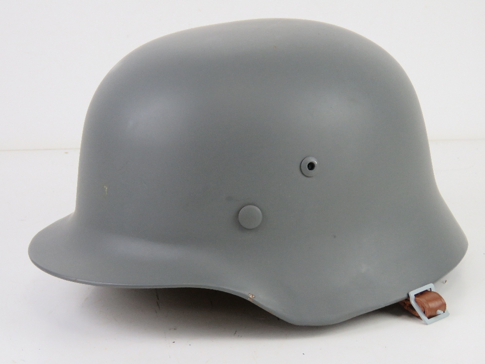 A reproduction M35 helmet with repro tan water helmet cover, with liner and chin strap. - Image 2 of 5