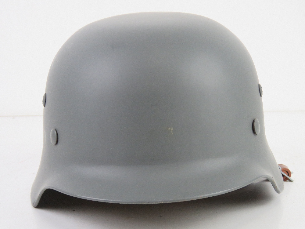 A reproduction M35 helmet with repro tan water helmet cover, with liner and chin strap. - Image 3 of 5