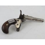 An antique nickel plated German 6mm Blank Calibre Derringer.