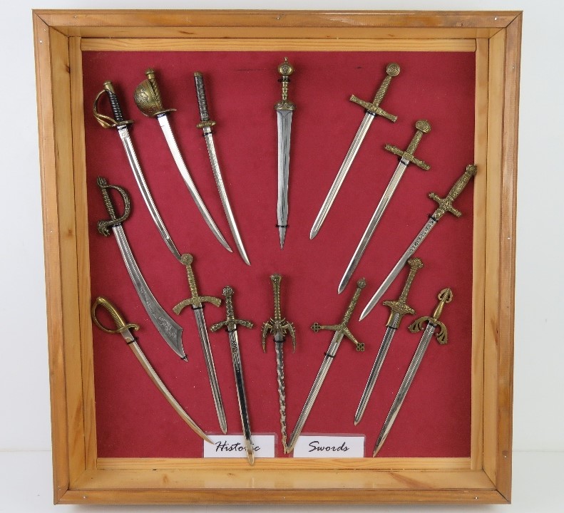 A collection of decorative miniature letter opener sized swords of historic themes, fifteen items.