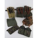 A quantity of assorted reproduction militaria; WWII German MP40 magazine pouches,